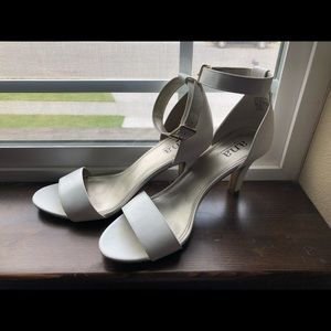 Ivory colored open-toed high heels.